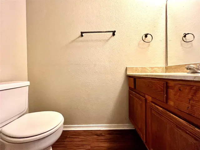 a bathroom with a toilet a sink and vanity