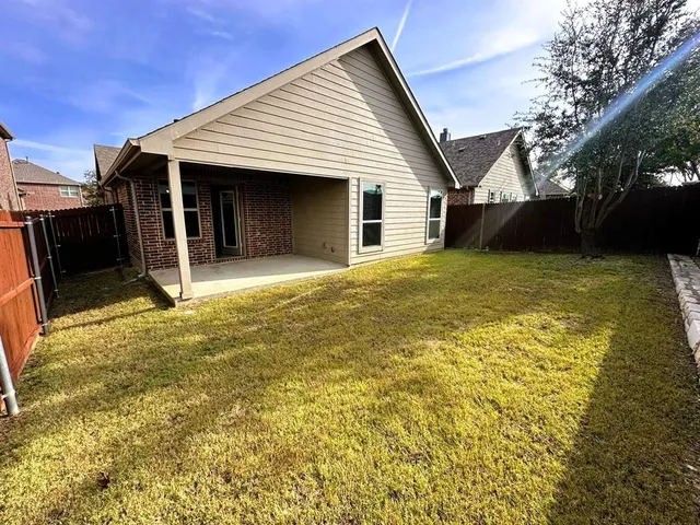 a view of a house with a yard and garage