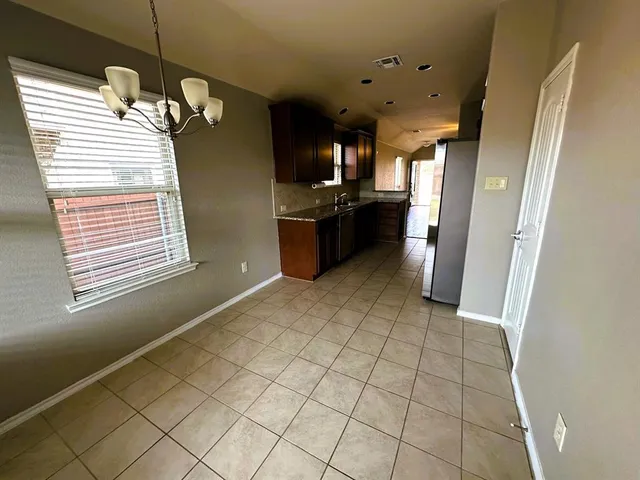 a kitchen with stainless steel appliances a refrigerator and a sink