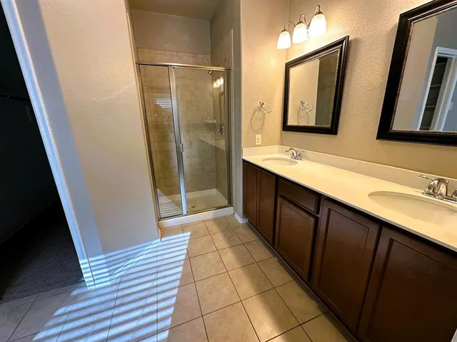 a bathroom with a double vanity sink and mirror