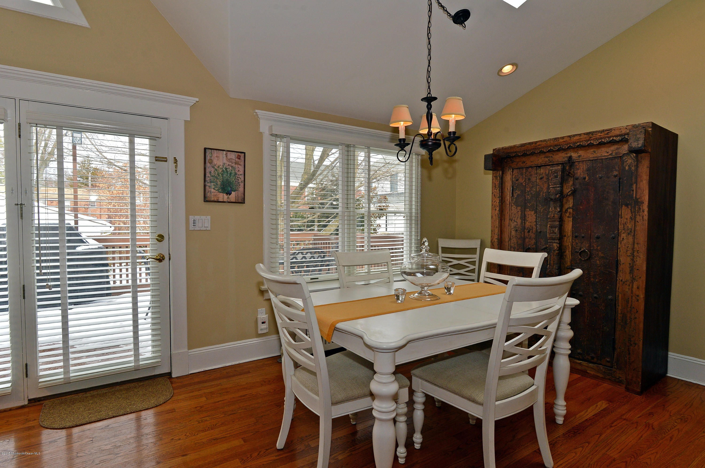 66 Pinckney Road Red Bank, NJ 07701 - Photo 14 of 30 a dining room with wooden floor a chandelier a wooden table and chairs