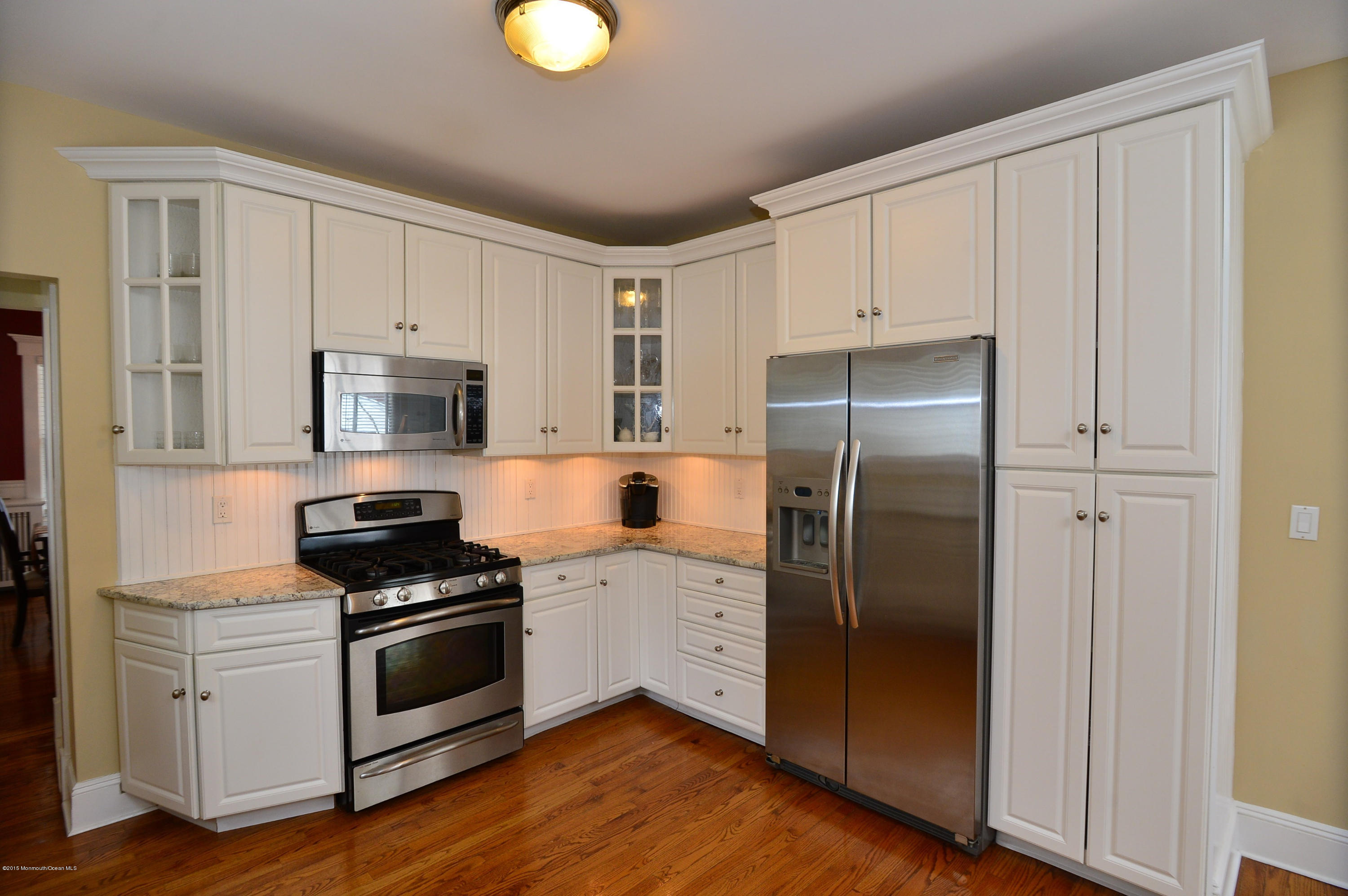 66 Pinckney Road Red Bank, NJ 07701 - Photo 16 of 30 a kitchen with white cabinets and stainless steel appliances