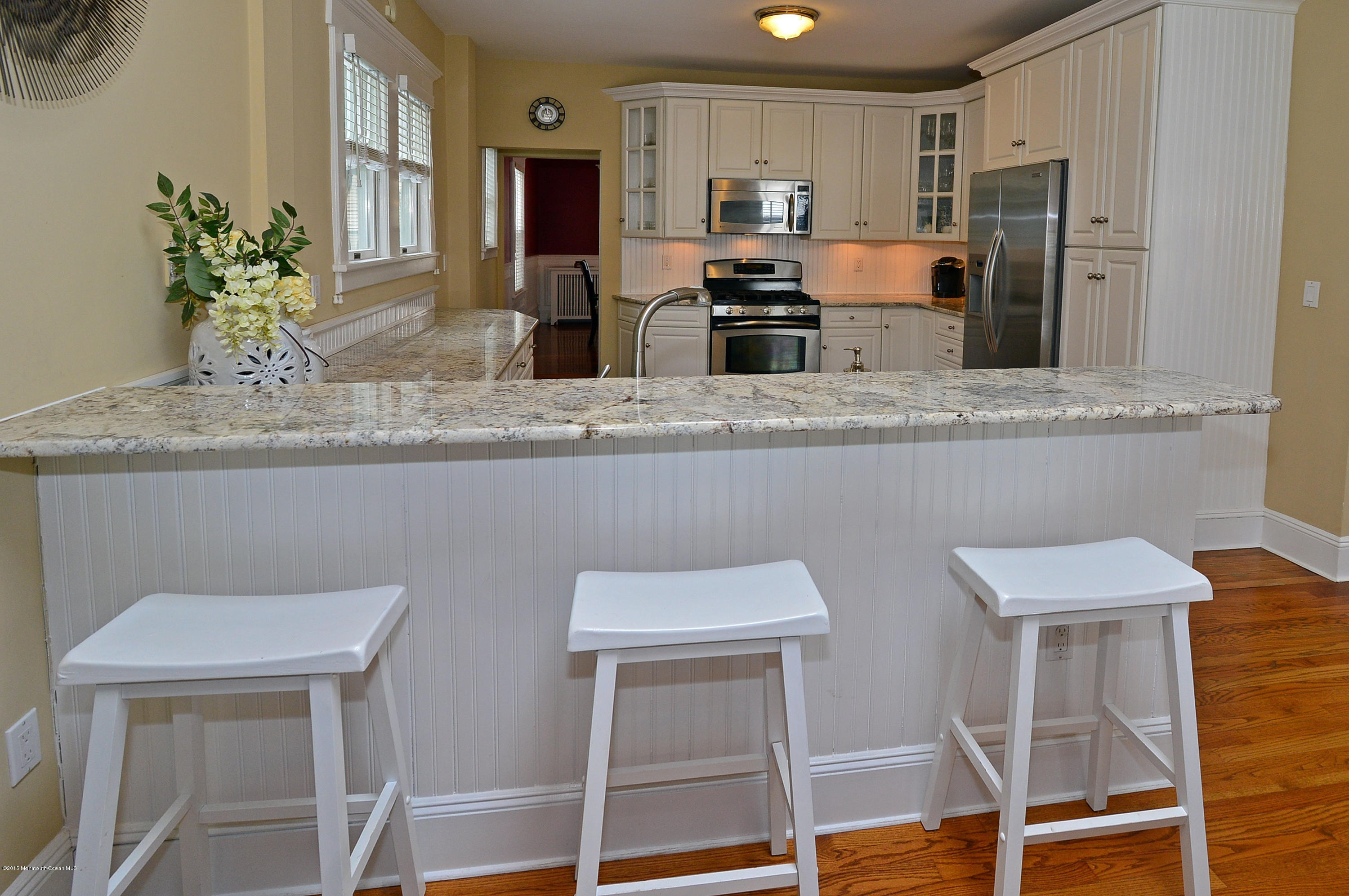 66 Pinckney Road Red Bank, NJ 07701 - Photo 20 of 30 a kitchen with stainless steel appliances granite countertop a table chairs stove refrigerator and microwave