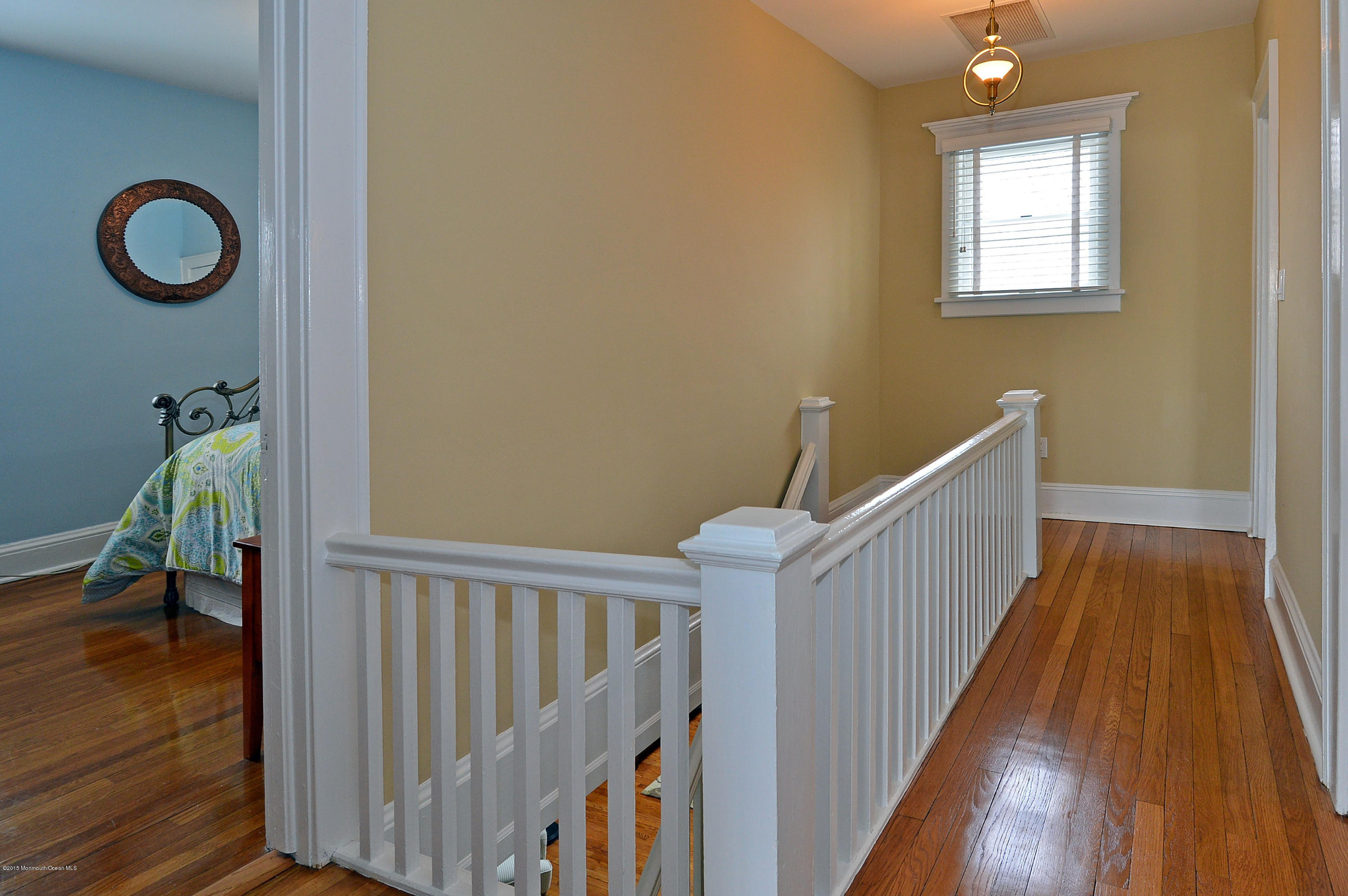 66 Pinckney Road Red Bank, NJ 07701 - Photo 27 of 30 a view of a hallway with wooden floor and stairs