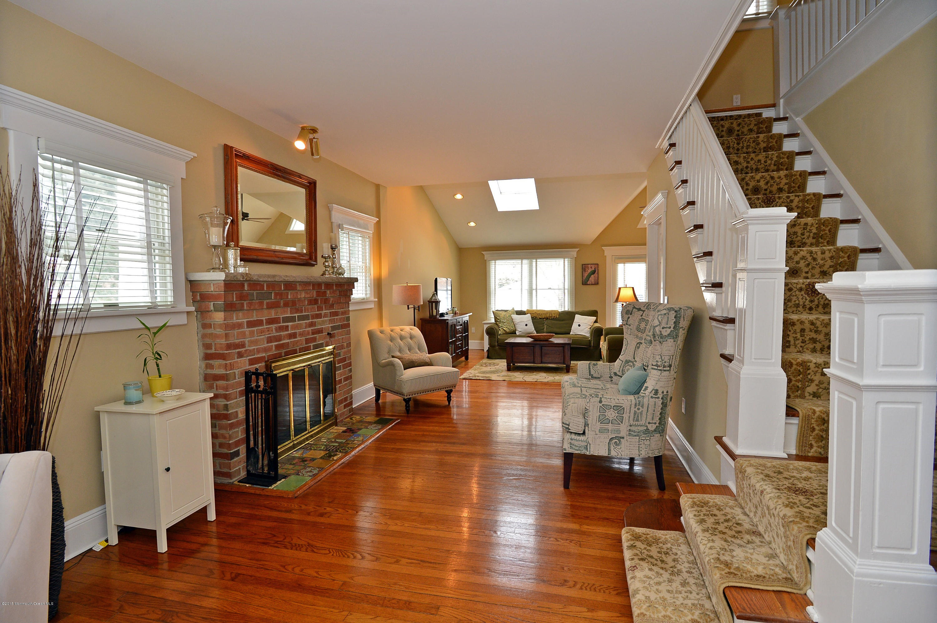 66 Pinckney Road Red Bank, NJ 07701 - Photo 9 of 30 a living room with furniture wooden floor and a fireplace