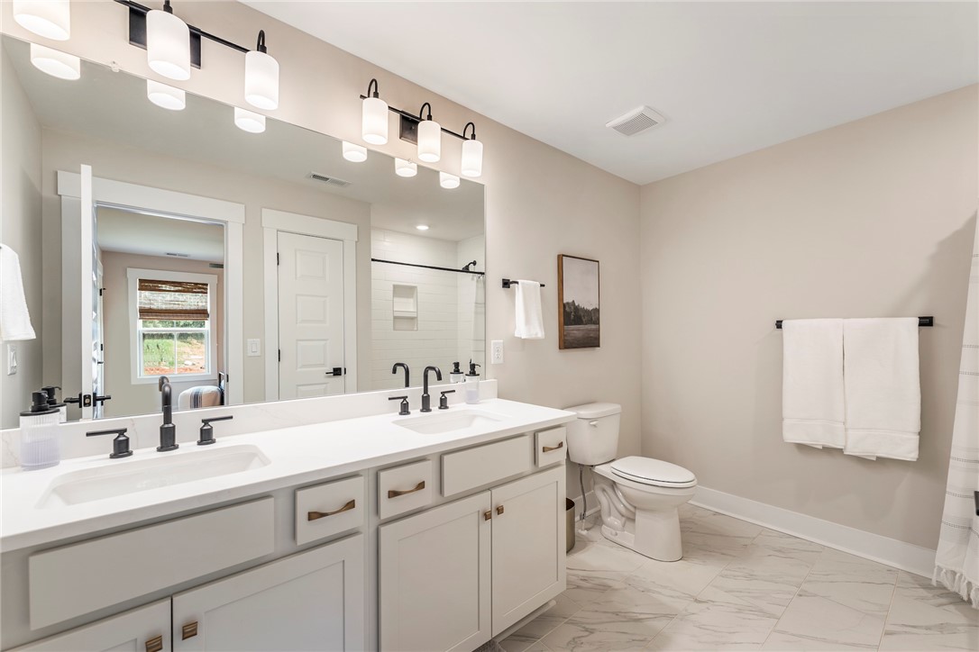 506 Tilman Court Anderson, SC 29621 - Photo 20 of 20 This primary bathroom offers dual sinks, contemporary fixtures, and a spacious vanity with ample storage.
