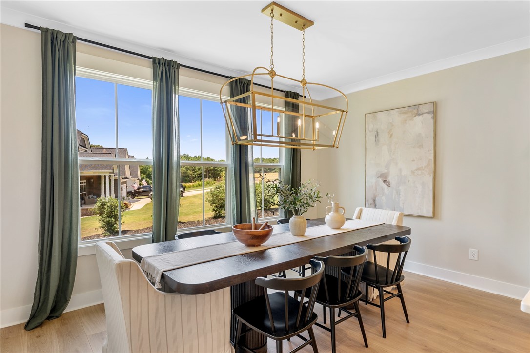 506 Tilman Court Anderson, SC 29621 - Photo 9 of 20 This bright dining area features ample natural light and a chic light fixture.