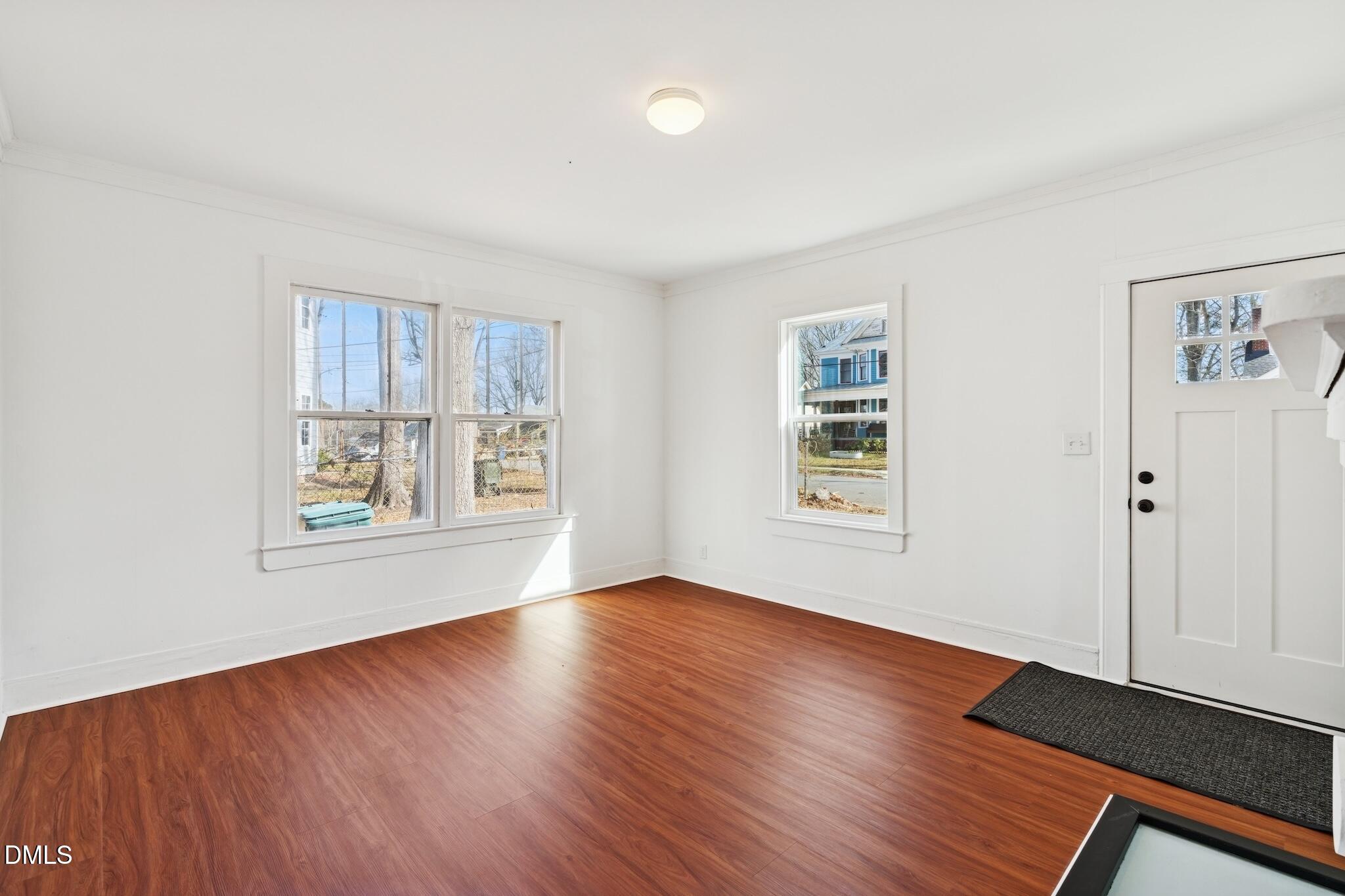705 North Driver Street Durham, NC 27703 - Photo 12 of 46 a view of an empty room with window and wooden floor