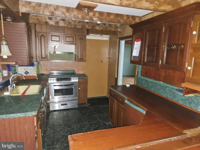 a kitchen that has a sink and a stove