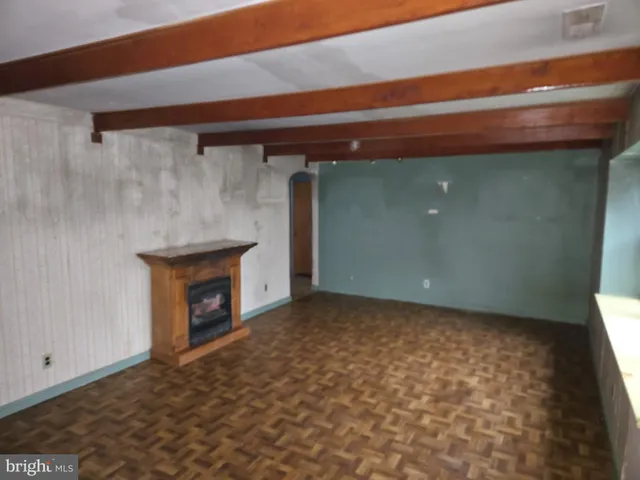 a view of empty room with a fireplace