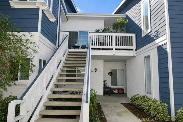 a view of staircase with railing and a potted plant