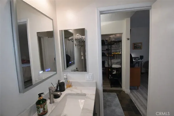 a bathroom with a sink a mirror and shower