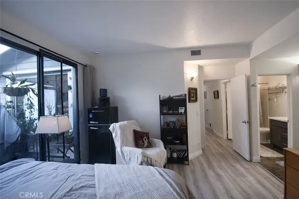a bedroom with furniture and a flat screen tv