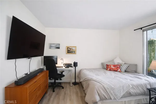 a bedroom with a bed and a flat screen tv
