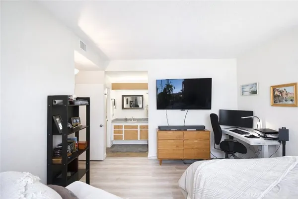 a bedroom with a bed and a flat screen tv