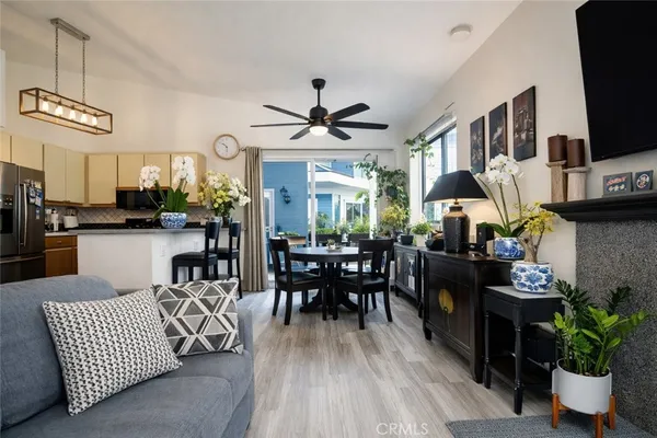 a living room with furniture dining area and a flat screen tv