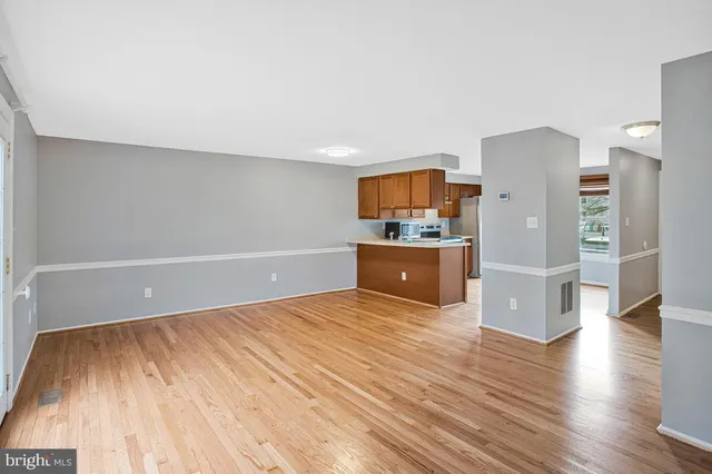 a view of a room with wooden floor and electronic appliances
