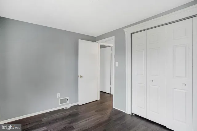 a view of an empty room and wooden floor