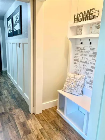 a view of an entryway with wooden floor