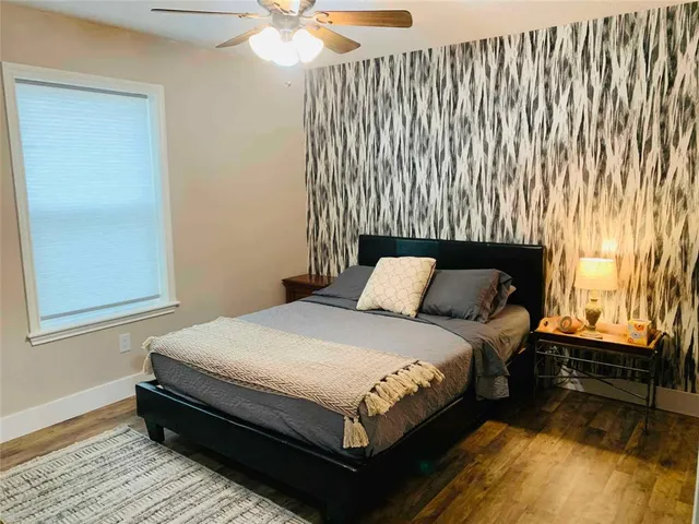 a bed sitting in a bedroom next to a window