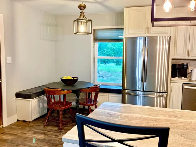 a view of a dining room with furniture and a window
