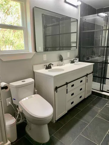 a bathroom with a sink toilet and shower