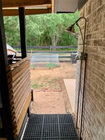a view of a balcony with wooden floor and fence