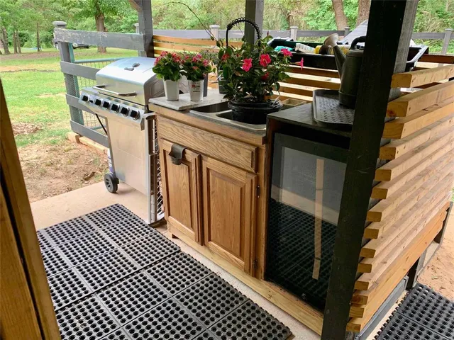 a view of a balcony with wooden floor and outdoor seating
