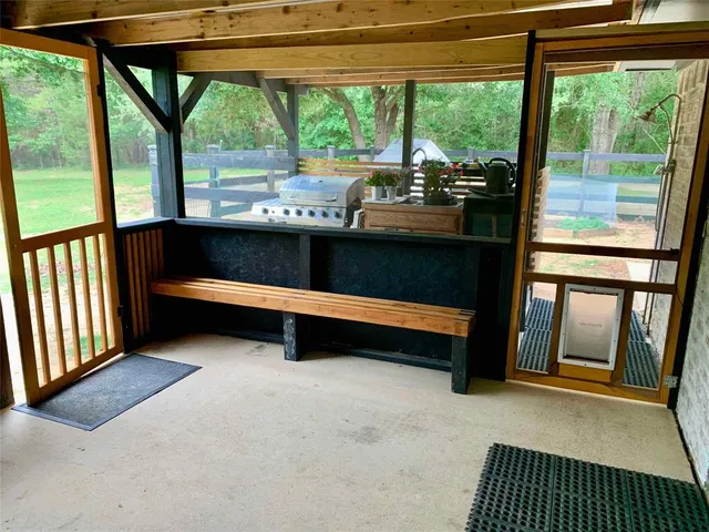 a view of a room with wooden floor and furniture