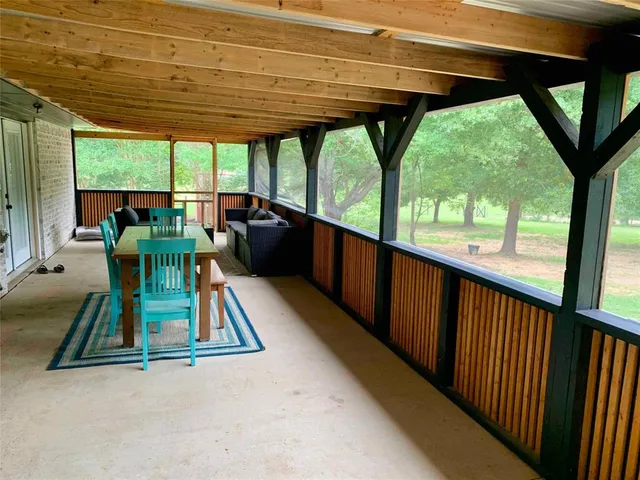 a view of porch with furniture and a yard