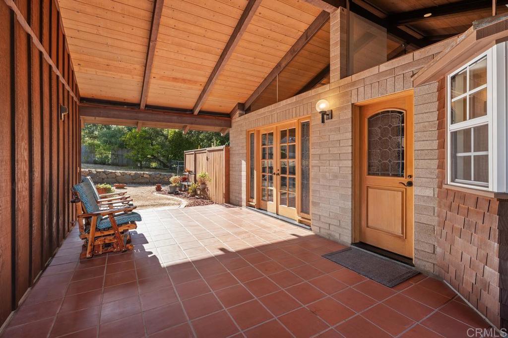 16522 Orchard Bend Road Poway, CA 92064 - Photo 2 of 26 a view of a porch with furniture and floor to ceiling window