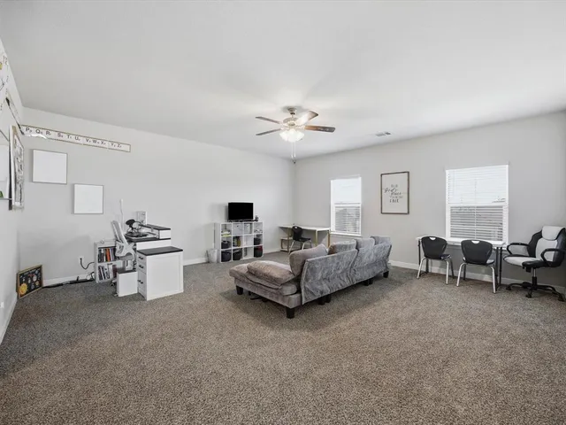 a living room with furniture and white walls