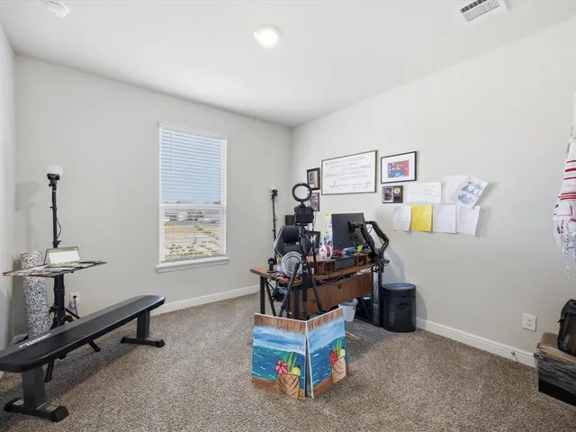 a view of a room with workspace and a window
