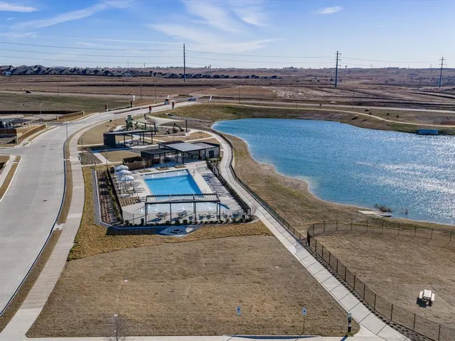 a view of a swimming pool with outdoor seating