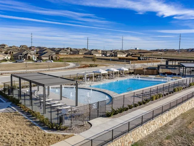 a view of a swimming pool and an outdoor seating