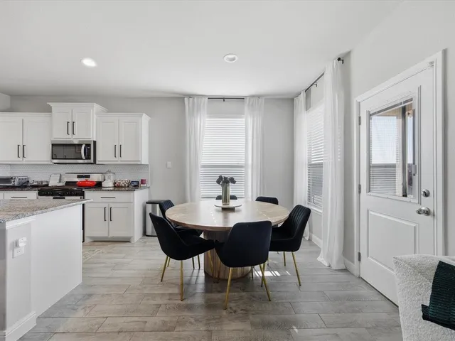 a kitchen with stainless steel appliances kitchen island granite countertop a sink and cabinets