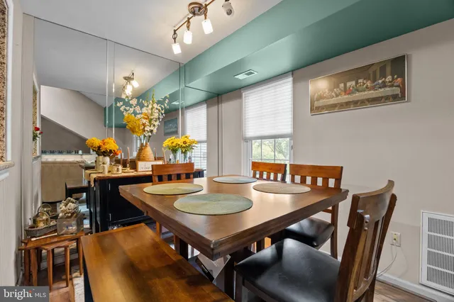 a view of a dining room with furniture and chandelier