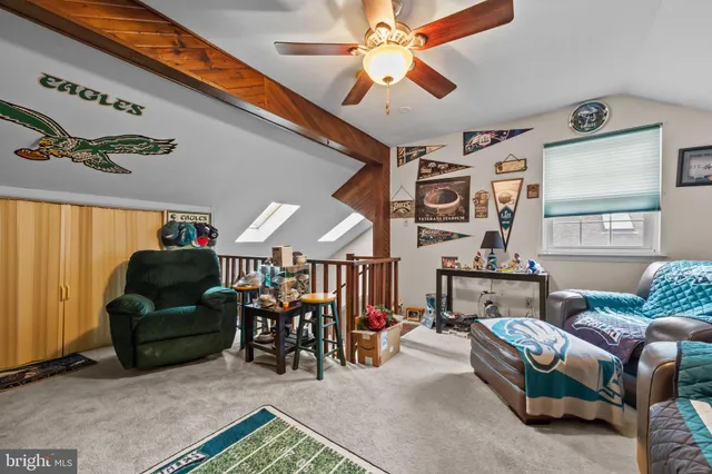 a living room with furniture and a ceiling fan