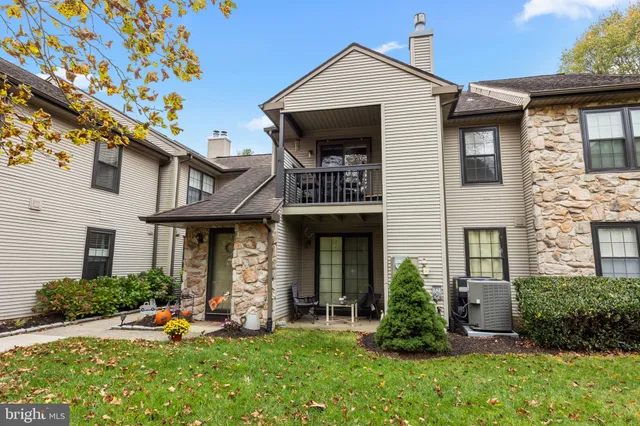 a front view of a house with garden and plants