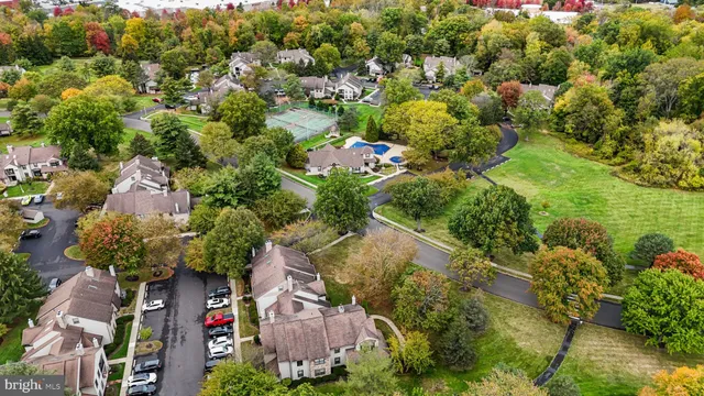 an aerial view of a house with a yard swimming pool and outdoor seating