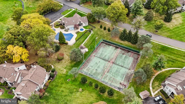 an aerial view of a house with a yard and lake view