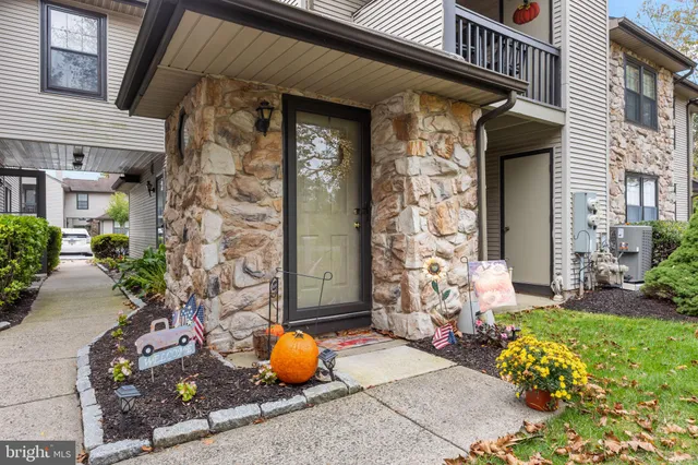 front view of a brick house with potted plants