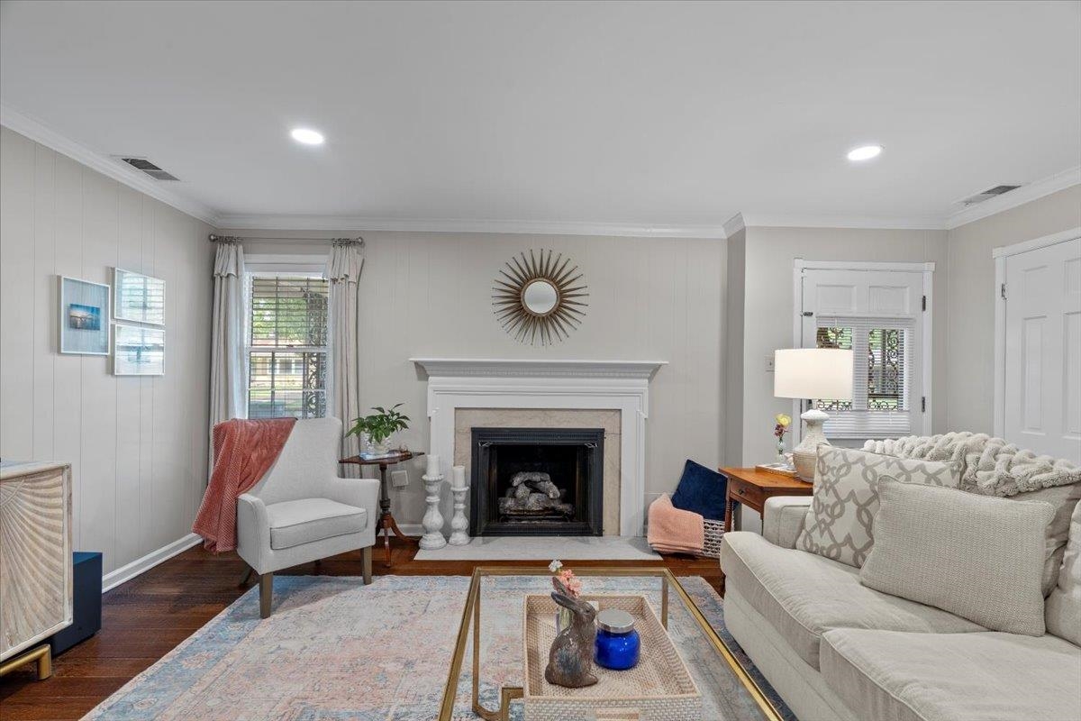 4491 Garnett Road Memphis, TN 38117 - Photo 4 of 32 Living area featuring a fireplace with a white mantel, dark wood-finish flooring, recessed lighting, and crown molding