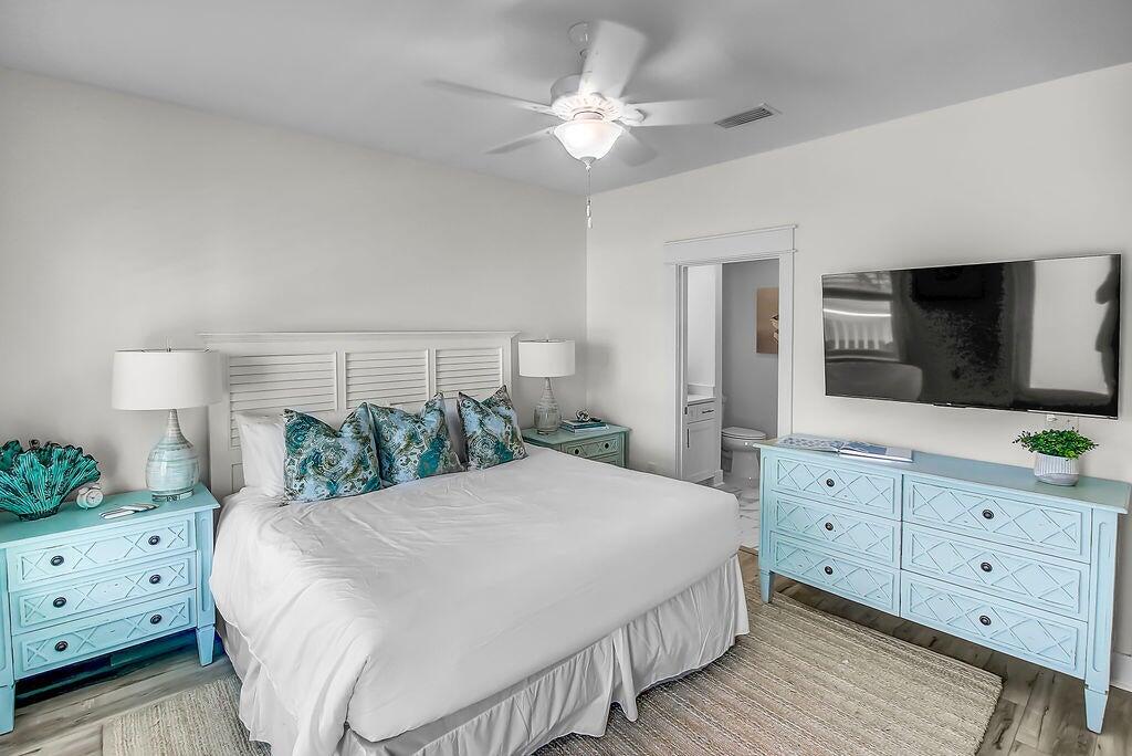 15 Constant Avenue Santa Rosa Beach, FL 32459 - Photo 19 of 66 a spacious bedroom with a large bed and a flat tv screen on dresser