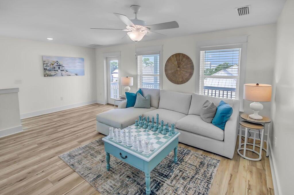 15 Constant Avenue Santa Rosa Beach, FL 32459 - Photo 42 of 66 a living room with furniture a rug potted plant and a window