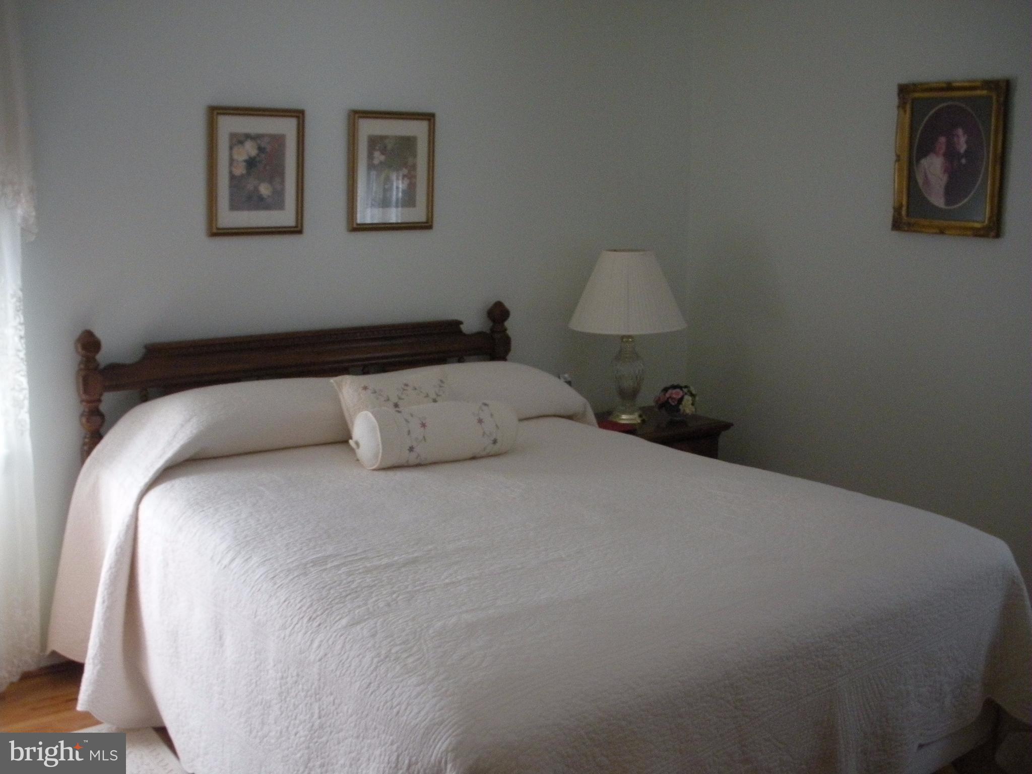 8803 Parlo Road Baltimore, MD 21236 - Photo 13 of 29 a bed room with a bed and a lamp