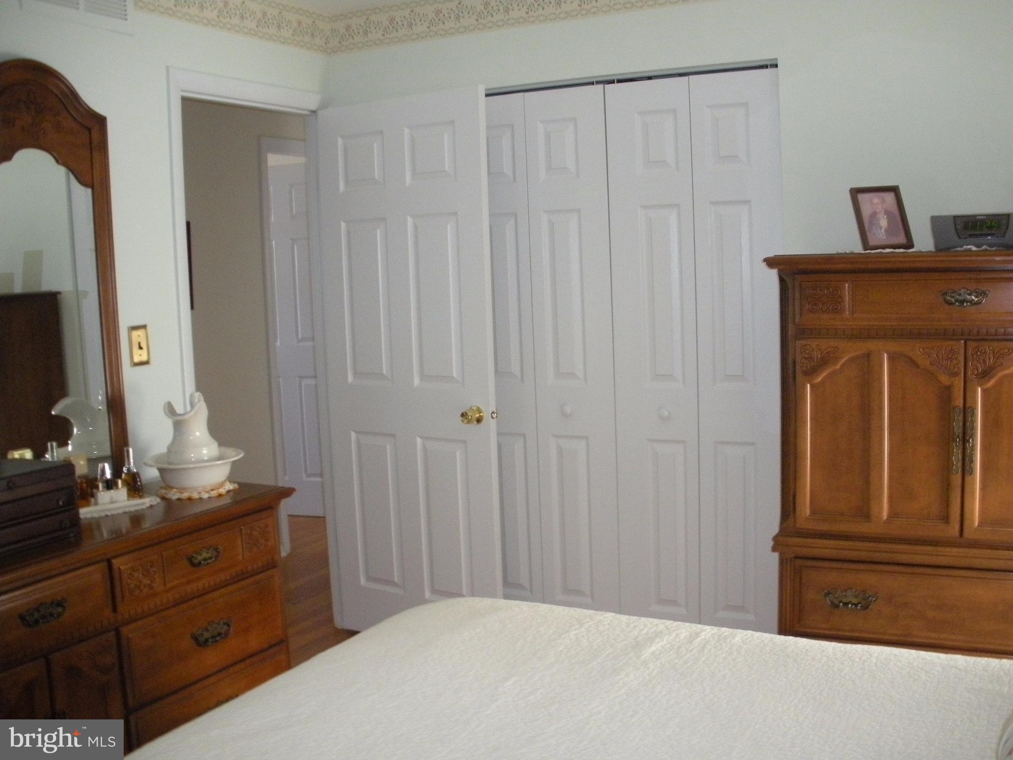 8803 Parlo Road Baltimore, MD 21236 - Photo 14 of 29 a bedroom with a bed and a dresser