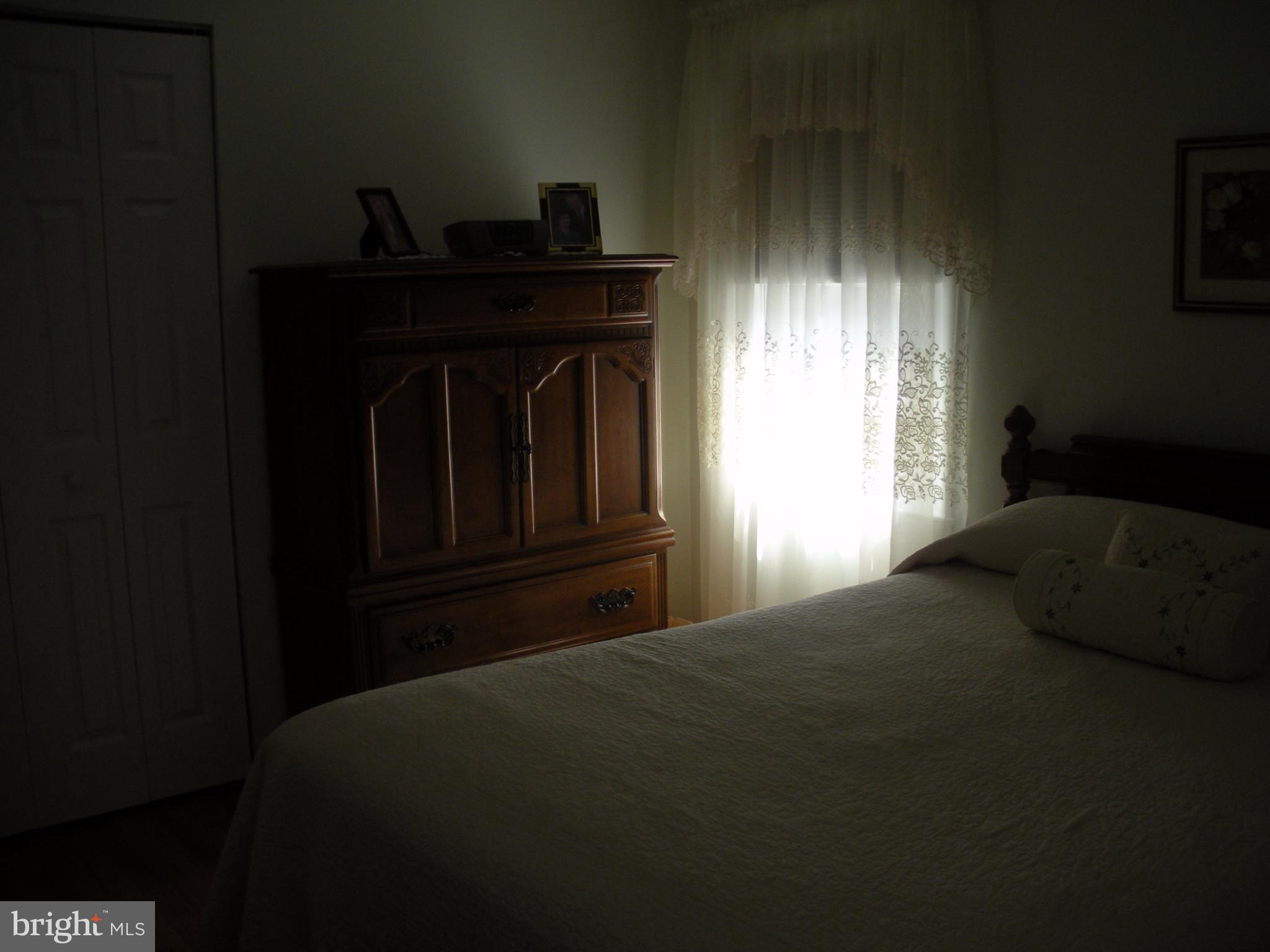 8803 Parlo Road Baltimore, MD 21236 - Photo 15 of 29 a bedroom with a bed next to a window