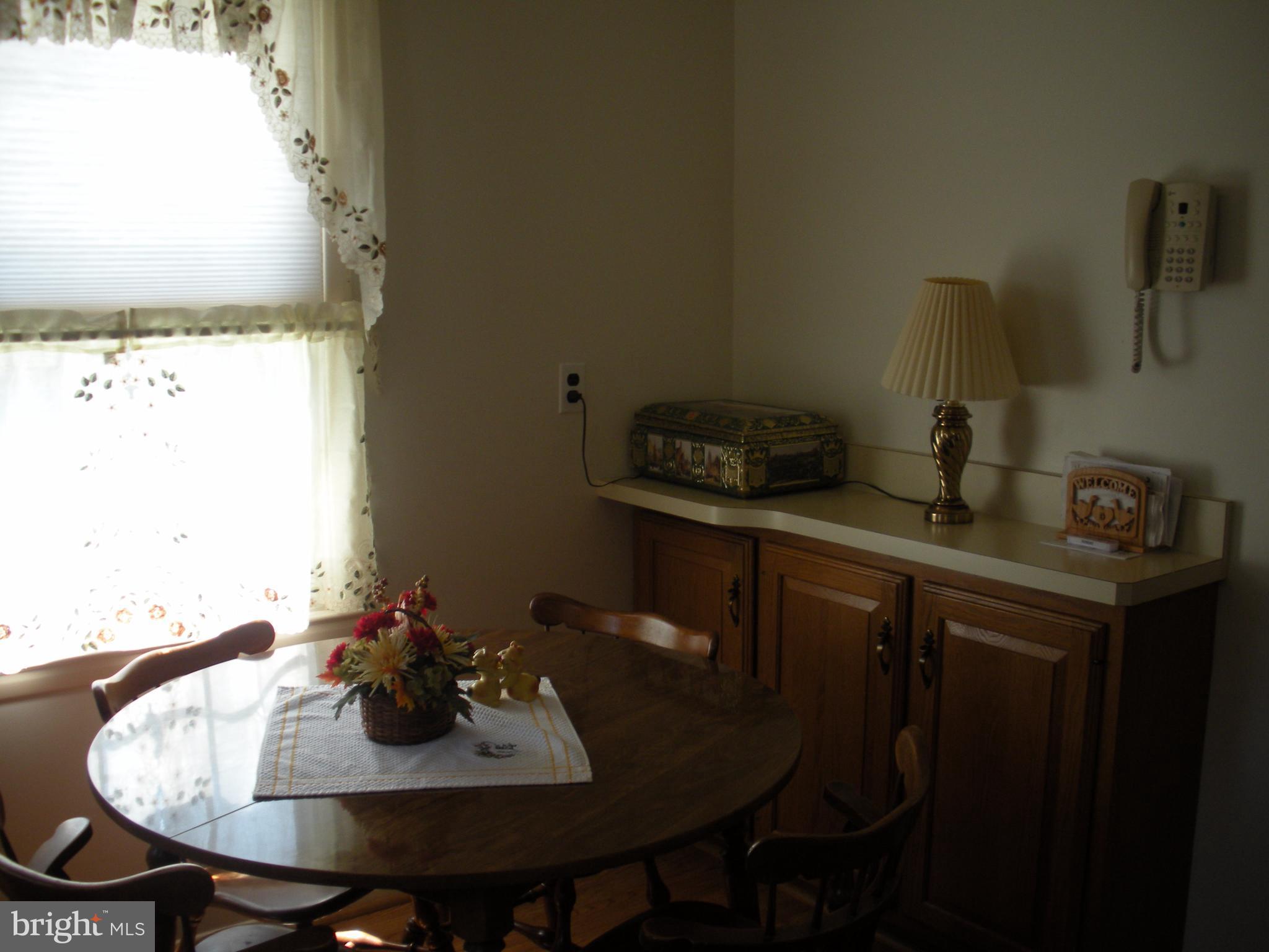 8803 Parlo Road Baltimore, MD 21236 - Photo 5 of 29 a view of a dining room with furniture and wooden floor