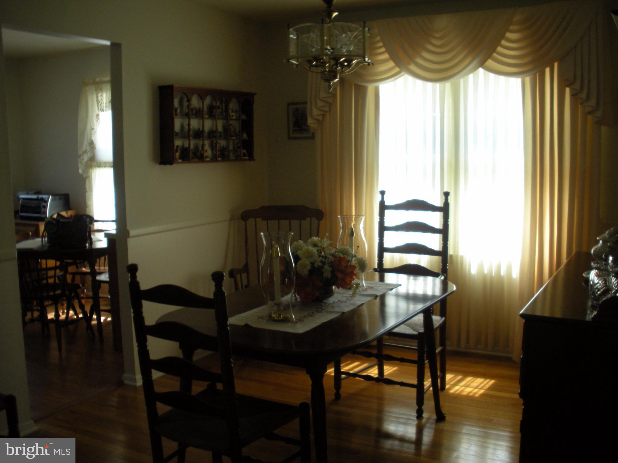 8803 Parlo Road Baltimore, MD 21236 - Photo 7 of 29 a view of a dining room with furniture and wooden floor